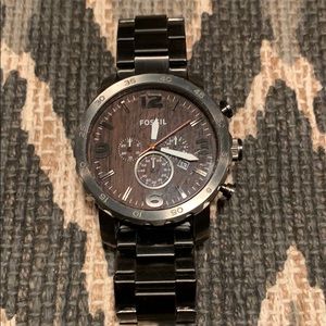 Gunmetal watch with woodgrain face.